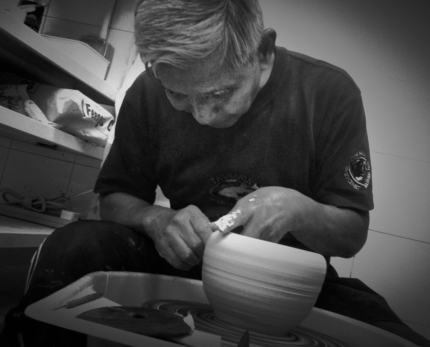 A master potter working with clay on a pottery wheel, a traditional craftsmanship and creative skill.